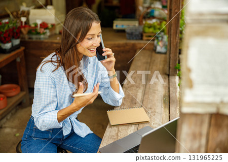 A Woman Engaged in a Delightful Conversation at a Colorful Floral Shop Just Like This One A Woman Engaged in a Delightful Conversation at a Colorful Floral Shop Just Like This One 131965225