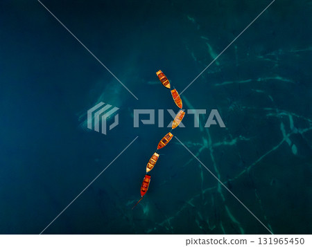 An Abstract Aerial View Showcasing the Beautiful Colorful Boats on the Deep Blue Water 131965450