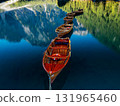 The tranquil lake, dotted with colorful boats, is embraced by majestic mountains, creating beauty 131965460