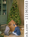 Children open Advent calendar gift boxes in the living room by the Christmas tree. There's a surprise in every box every day of December.  Waiting for the new year 131965683