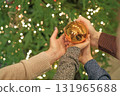 Christmas tree ball toy in the hands of children and parents. The atmosphere of New Year's mood 131965688