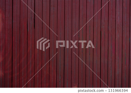 Dark red wooden wall with vertical planks, subtle natural texture, showcasing weathered wood surface in moody trendy color of year. Concept of wood texture, rustic background, vintage atmosphere 131966394