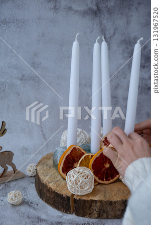 Step by step instruction of making handmade Christmas advent four weeks candle calendar. Female hands creating craft homemade decor. New year celebration. Winter holidays Step by step instruction of making handmade Christmas advent four weeks candle calendar. Female hands creating craft homemade decor. New year celebration. Winter holidays 131967520