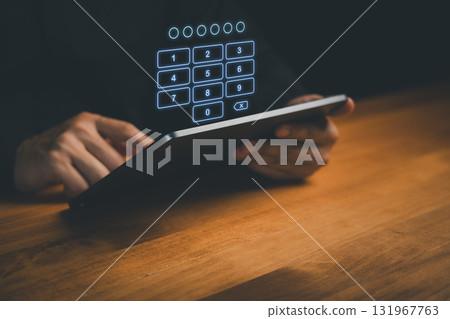 Person using tablet with digital keypad for PIN code entry, symbolizing cybersecurity, data protection, online privacy, secure login, authentication, mobile banking and digital access security. 131967763