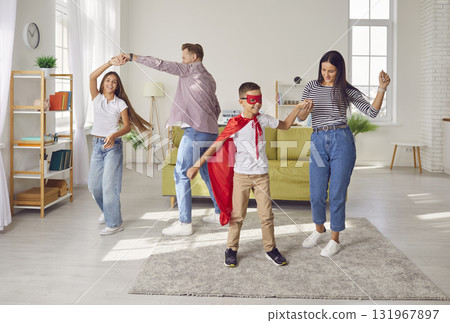 Full length photo of a happy family having fun with children in the living room at home. Full length photo of a happy family having fun with children in the living room at home. 131967897