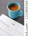 Resume - Image of a person preparing a resume, which is essential for job hunting, while drinking coffee 131968160