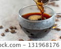 Pour drip coffee into a coffee cup 131968176