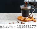 Pouring drip coffee into a coffee cup (with copy space) 131968177