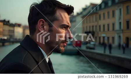 Man in formal suit standing on city street with serious expression during daytime 131969269