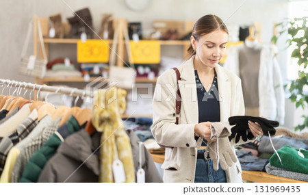 Woman chooses warm gloves Woman chooses warm gloves 131969435