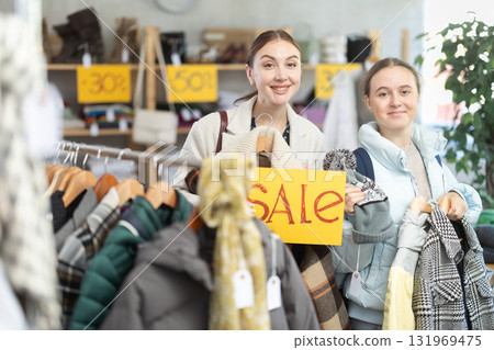 Woman on sale with her daughter in a clothing store 131969475