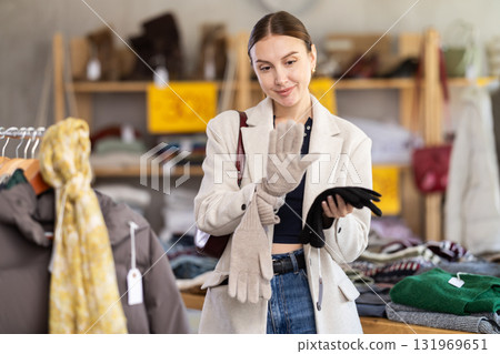 Woman chooses warm gloves Woman chooses warm gloves 131969651