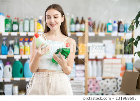 Woman view trademark sign on label, chooses eco friendly dishwashing detergent Woman view trademark sign on label, chooses eco friendly dishwashing detergent 131969693