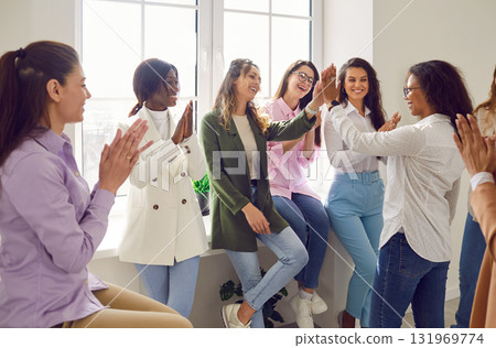 Happy women colleagues giving high five at meeting celebrating success or business achievement. Happy women colleagues giving high five at meeting celebrating success or business achievement. 131969774
