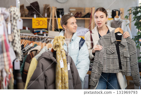 Adult woman and teenage girl choosing coat 131969793