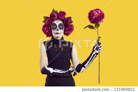 Young woman with sugar skull makeup in red peonies wreath Young woman with sugar skull makeup in red peonies wreath 131969852