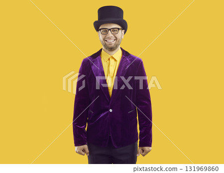 Portrait of a happy male entertainer in a purple velvet suit, top hat and glasses Portrait of a happy male entertainer in a purple velvet suit, top hat and glasses 131969860