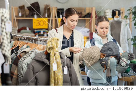 woman and her daughter choose hats woman and her daughter choose hats 131969929