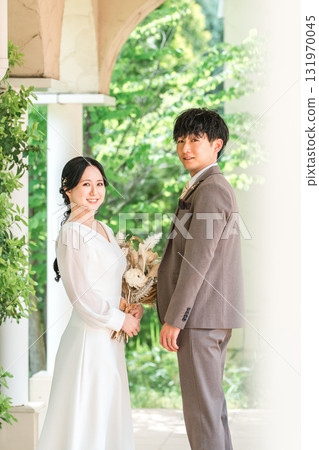 Bride and groom staring at each other with a bouquet (wedding, bridal, couple) Bride and groom staring at each other with a bouquet (wedding, bridal, couple) 131970045