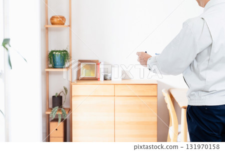 A man in work clothes checking furniture 131970158