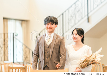 Bride and groom entering and leaving the wedding ceremony and reception 131970337