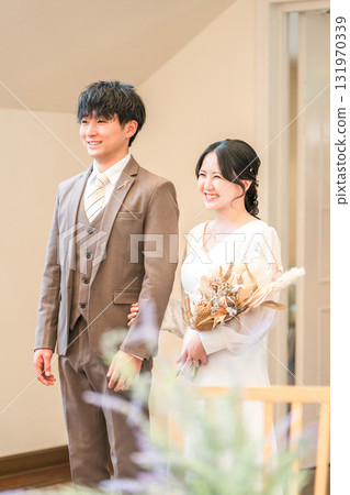 A bride and groom entering a chapel, wedding hall, and virgin road with a bouquet at a wedding ceremony A bride and groom entering a chapel, wedding hall, and virgin road with a bouquet at a wedding ceremony 131970339