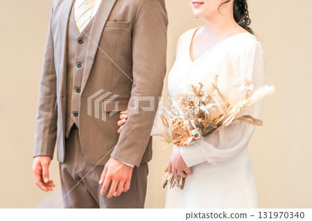 A bride and groom entering a chapel, wedding hall, and virgin road with a bouquet at a wedding ceremony A bride and groom entering a chapel, wedding hall, and virgin road with a bouquet at a wedding ceremony 131970340