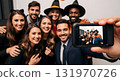 Group of friends taking a Halloween selfie with a phone 131970726