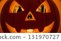 Halloween night family portrait through pumpkin carving face at home. 131970727