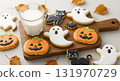 Festive Halloween Cookies with Milk on a Wooden Board 131970729