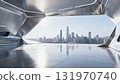 View the city skyline from the interior of a geometrically cut metal space capsule 131970740
