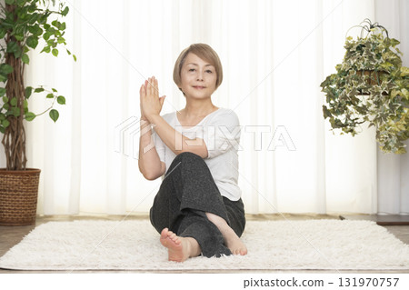 Senior woman doing Pilates in the living room Senior woman doing Pilates in the living room 131970757