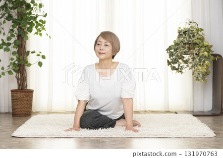 Senior woman doing Pilates in the living room Senior woman doing Pilates in the living room 131970763