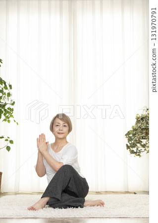 Senior woman doing Pilates in the living room Senior woman doing Pilates in the living room 131970791