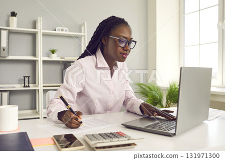 African american business woman accountant working on a laptop at office. 131971300