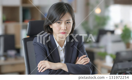 Businesswoman with arms crossed and angry expression 131972254