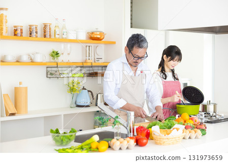 Kitchen: Middle-aged couple cooking Kitchen: Middle-aged couple cooking 131973659