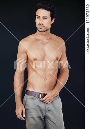 Model, man and muscle with tattoo on body in jeans for motivation with dark background. Male person, healthy and strong with sexy chest for training or shirtless after workout or exercise. Model, man and muscle with tattoo on body in jeans for motivation with dark background. Male person, healthy and strong with sexy chest for training or shirtless after workout or exercise. 131973880