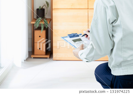 A man in work clothes checking furniture A man in work clothes checking furniture 131974225