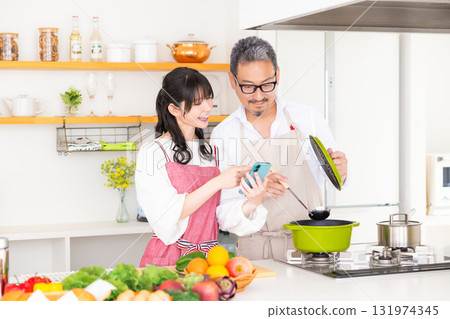 Kitchen: Middle-aged couple cooking 131974345