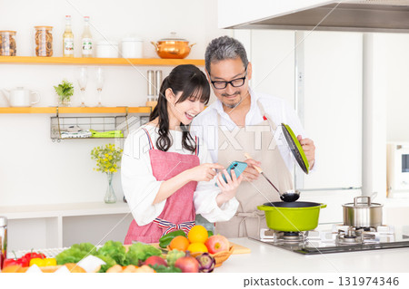 Kitchen: Middle-aged couple cooking Kitchen: Middle-aged couple cooking 131974346