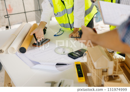 Architect Asian team working with colleagues in the construction site. Architecture engineering on big project. Architect Asian team working with colleagues in the construction site. Architecture engineering on big project. 131974999