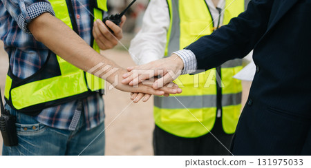 Asian Engineer and contractor join hands after signing contract,They are having a modern building project together. Asian Engineer and contractor join hands after signing contract,They are having a modern building project together. 131975033