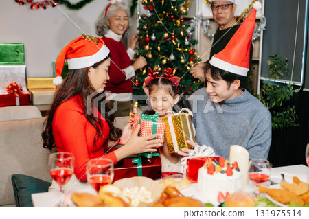 Celebrate Christmas with family in a cozy, festive setting filled with gifts, love, and joy. Celebrate Christmas with family in a cozy, festive setting filled with gifts, love, and joy. 131975514