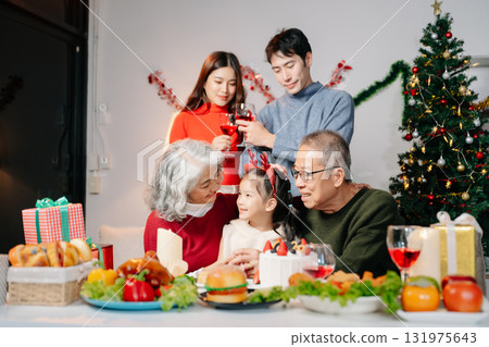 Celebrate Christmas with family in a cozy, festive setting filled with gifts, love, and joy. Celebrate Christmas with family in a cozy, festive setting filled with gifts, love, and joy. 131975643