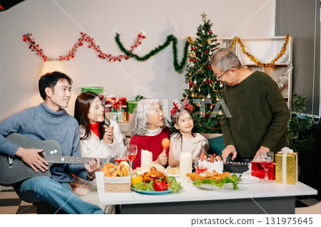 Celebrate Christmas with family in a cozy, festive setting filled with gifts, love, and joy. Celebrate Christmas with family in a cozy, festive setting filled with gifts, love, and joy. 131975645