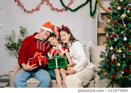 Celebrate Christmas with family in a cozy, festive setting filled with gifts, love, and joy. Celebrate Christmas with family in a cozy, festive setting filled with gifts, love, and joy. 131975664