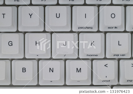 A tight close-up of the keys on a white keyboard A tight close-up of the keys on a white keyboard 131976423