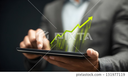 Man holding digital tablet with green upward chart 131977119