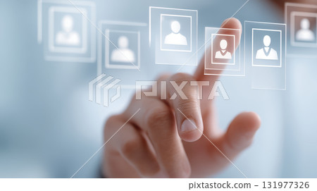 Automation and skills selection concept with hand interacting with virtual icons representing people for recruitment and human resource management 131977326